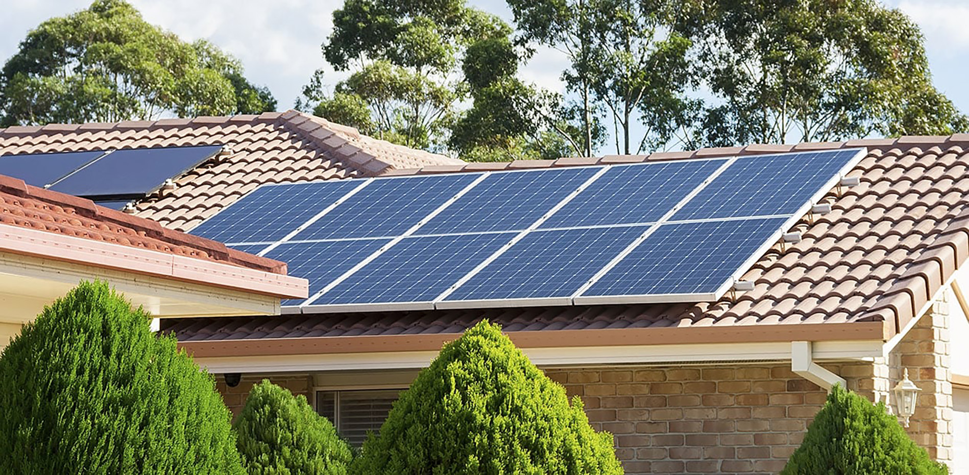 Suburban brick home with solar panels on roof