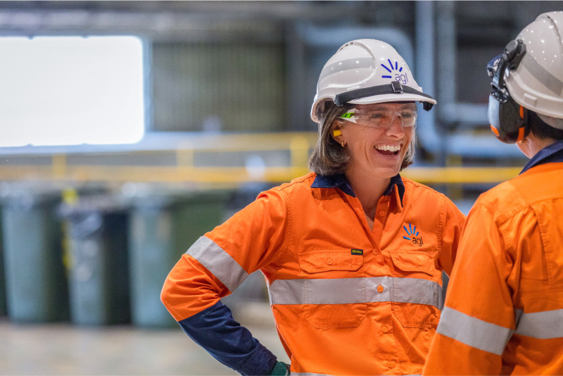 Female AGL employee laughing at one of our energy generation facilities