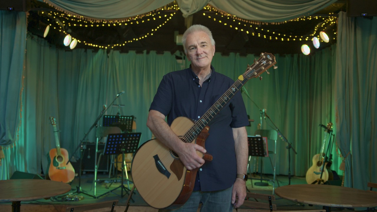 Geoff holding his guitar before a gig