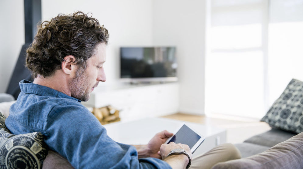 Man with tablet on couch
